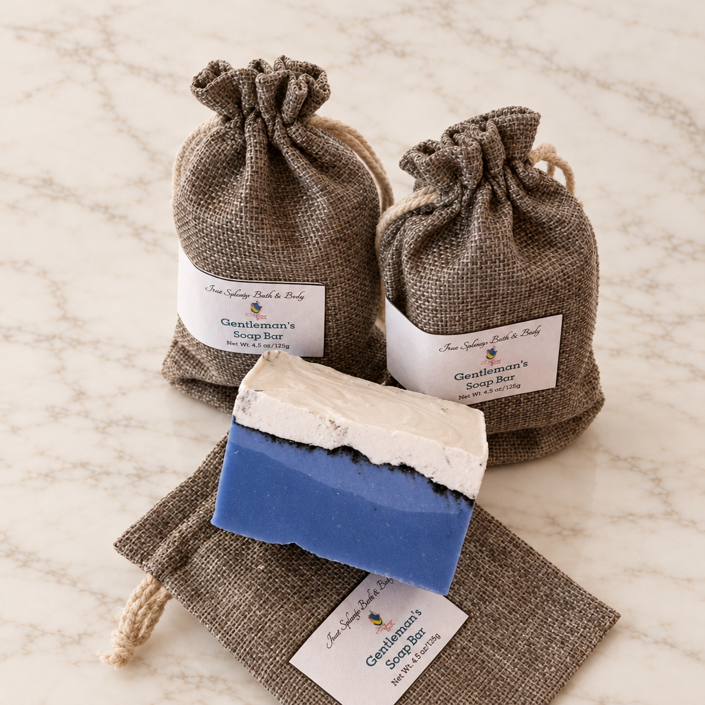 Blue-and-cream Gentleman's soap bar with brown fabric drawstring packaging on warm white marble.