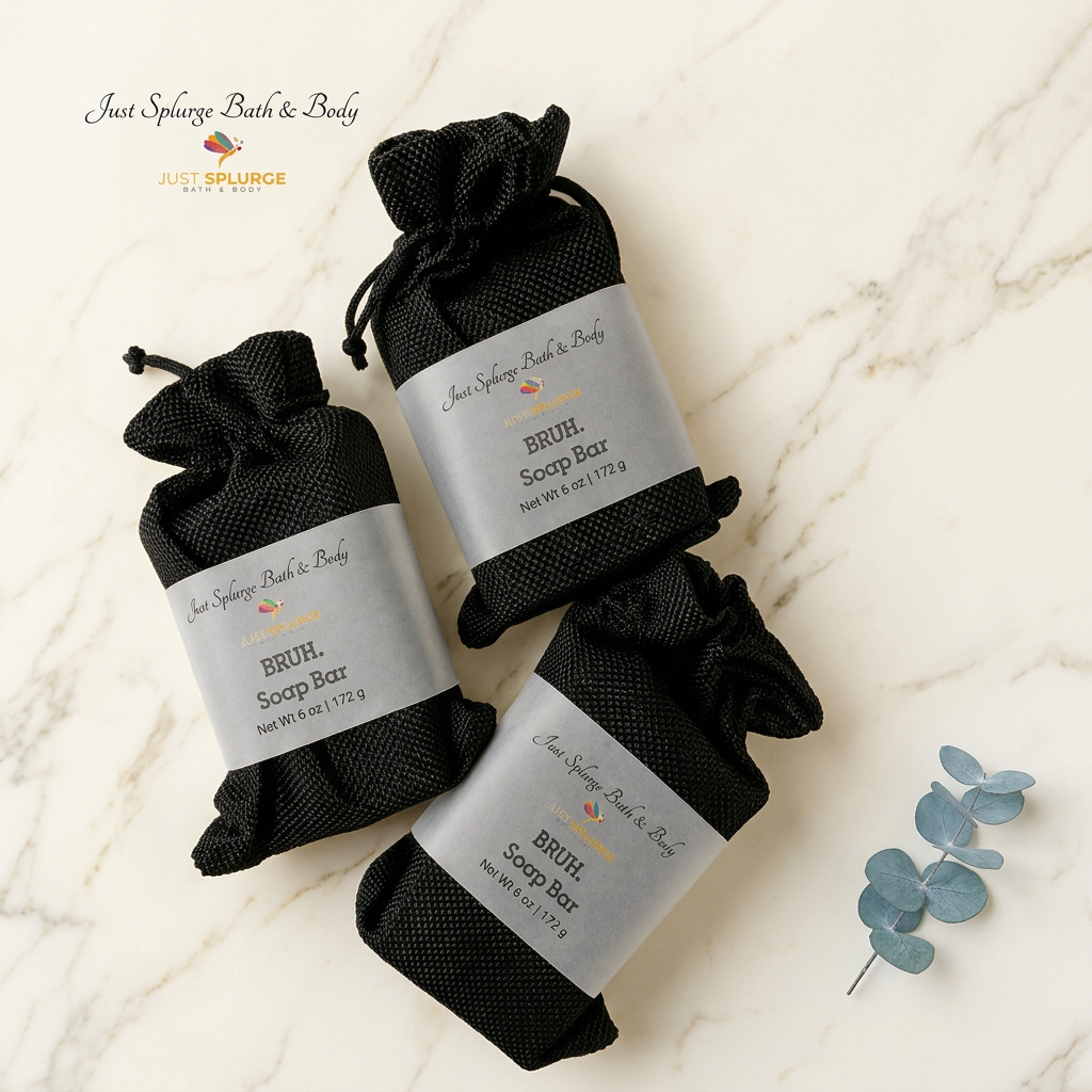 Three BRUH Soap Bars in black drawstring bags with paper labels on warm ivory marble with eucalyptus.