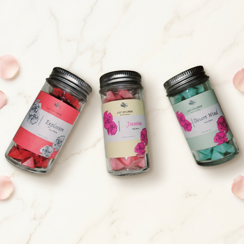 Three glass wax melt jars with black lids containing red, pink and turquoise wax pieces on ivory marble with blush petals.