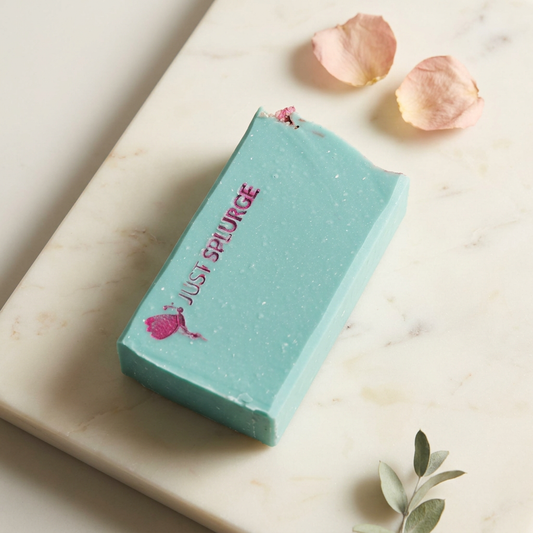Turquoise Cabaret Soap Bar with magenta Just SPLURGE stamp on ivory marble with blush petals and greenery.